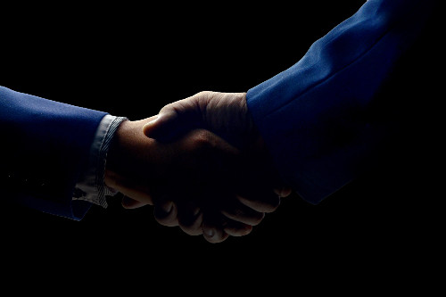 Hands shaking as a merger is agreed