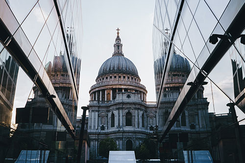 View of St Pauls from in between two buildings in London