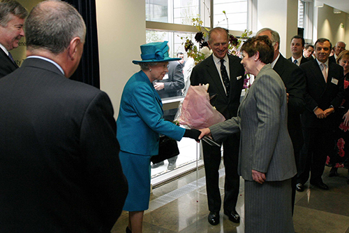 Presentation of bouquet to Queen Elizabeth 2nd by Mrs Gladys Parish, and longest serving member of staff at City, University of London.