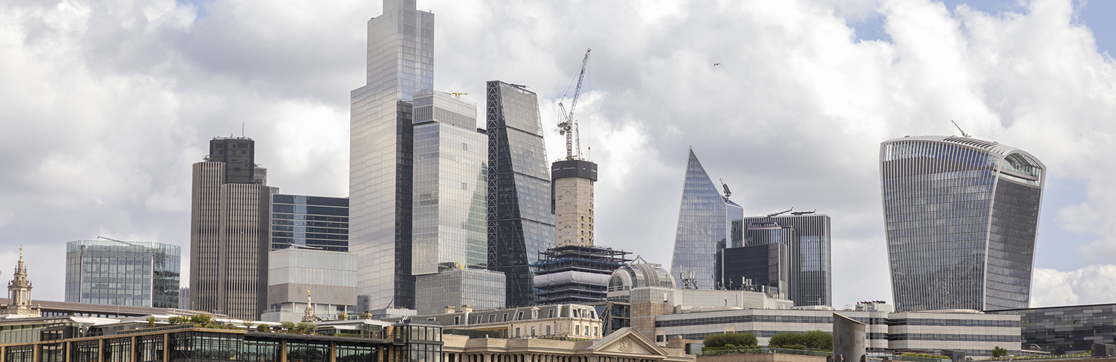 	London buildings overlooking the River Thames with a view of the skyline