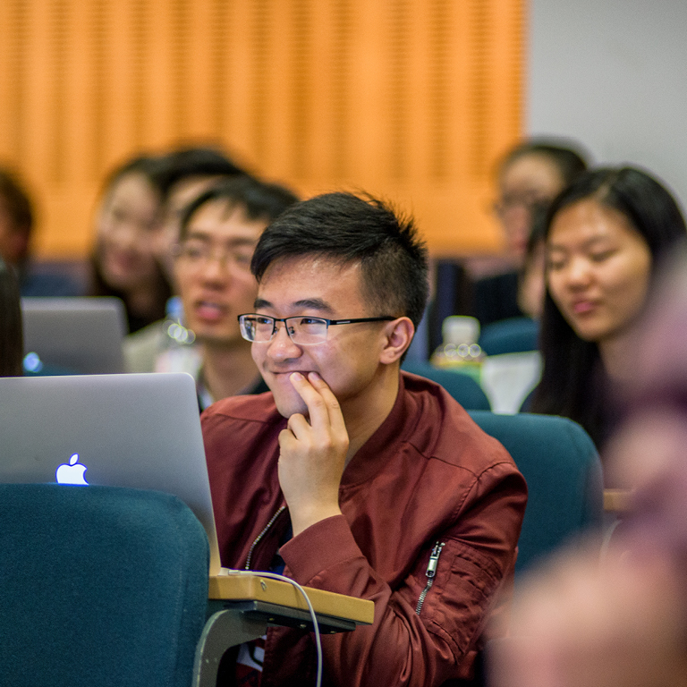 Asian male student listening attentively in a lecture class.