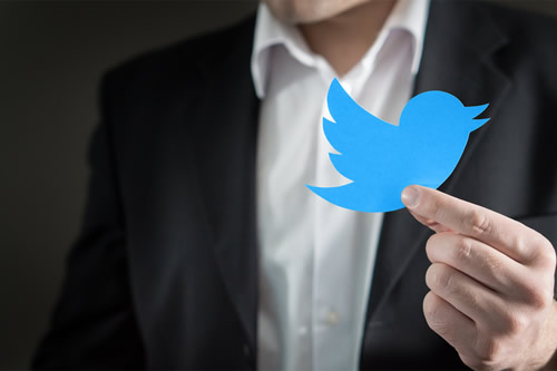 Corporate figure and Twitter logo