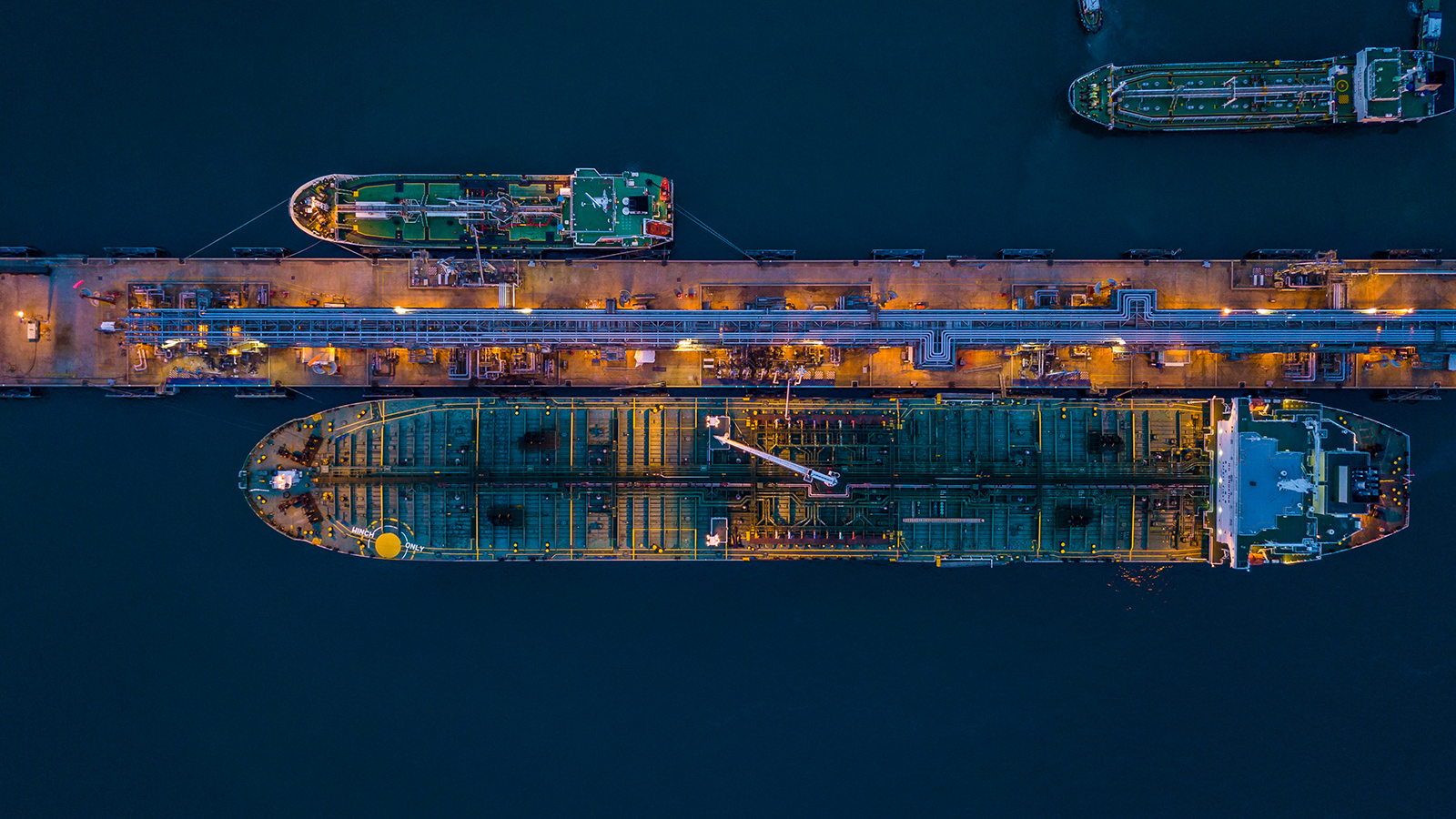 Aerial view oil tanker ship at the port in operation at night