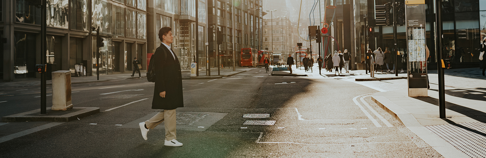 Male Bayes student walking along Bishopsgate, London 