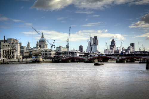 Image of the Thames and London skyline behind in the day time