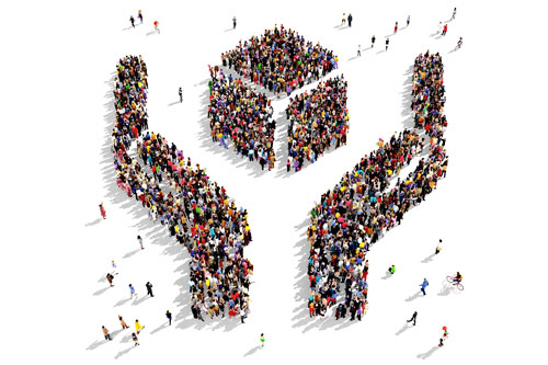 Large group of people seen from above gathered in the shape of two hands holding an abstract object