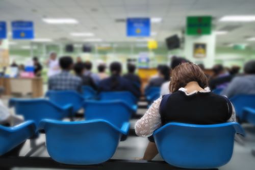 A woman waits in a hospital waiting room