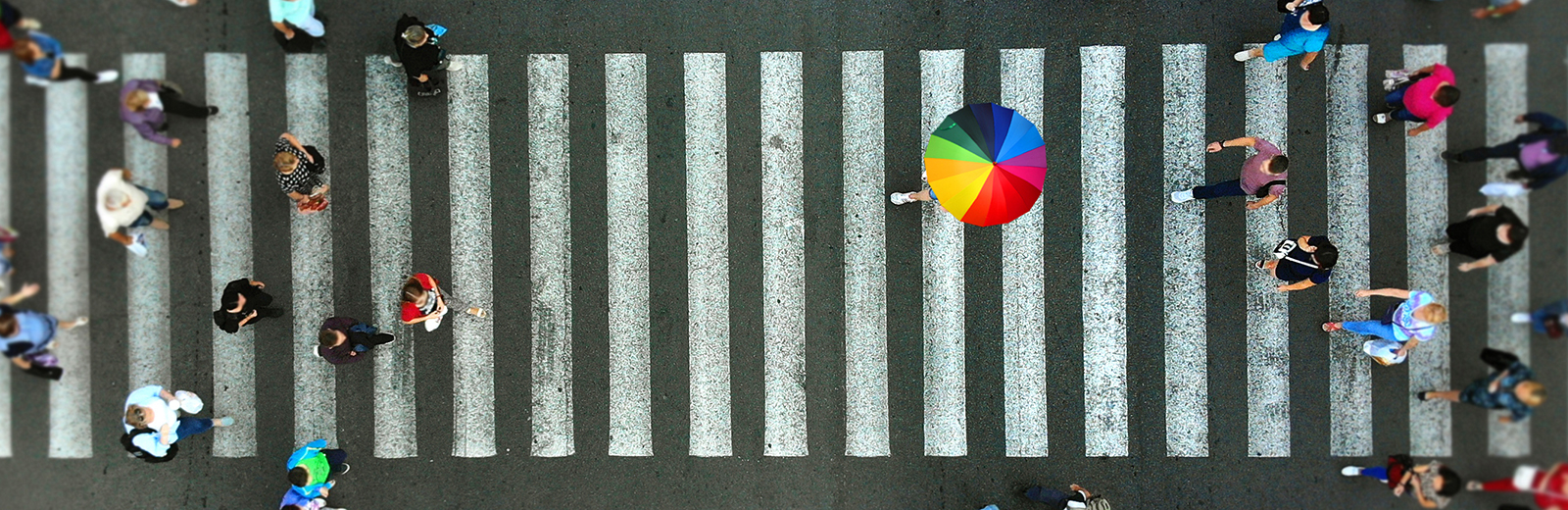 Rainbow umbrella over a pedestrian crossing
