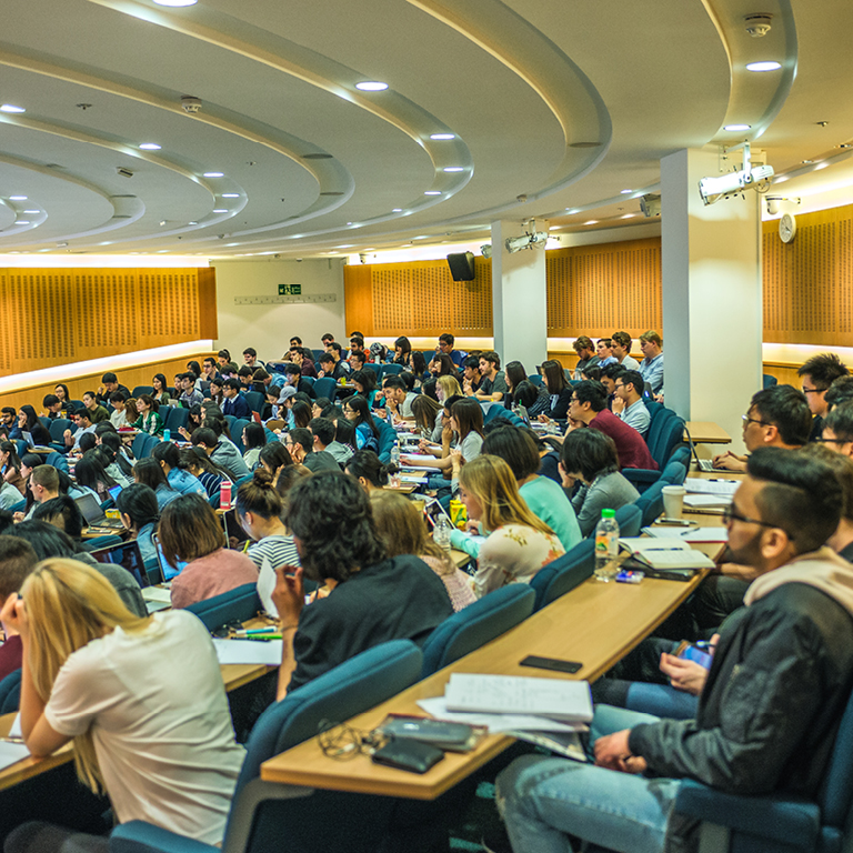 Finance students listening to a lecture in a large lecture hall