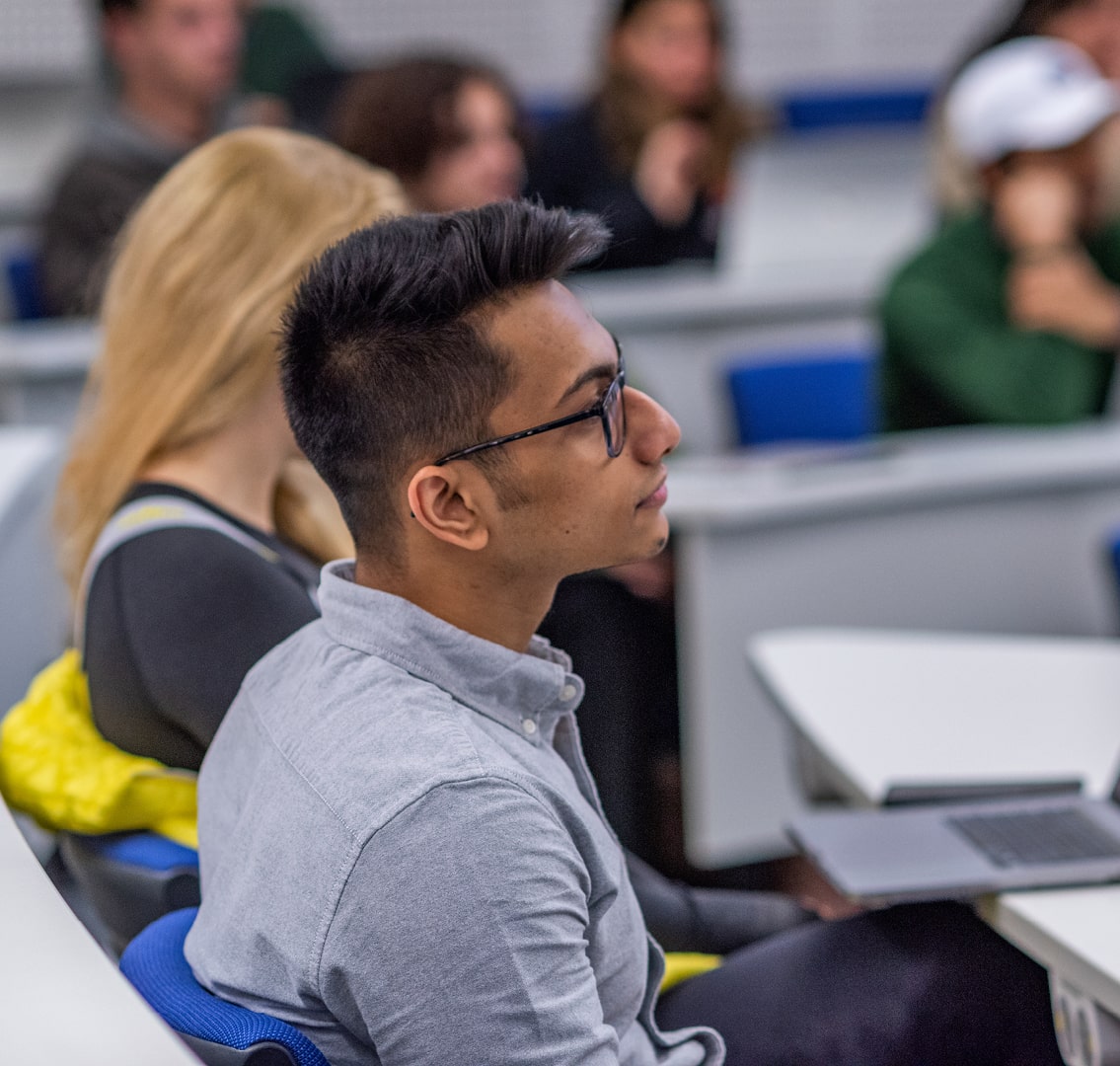 Male postgraduate student listening in a lecture