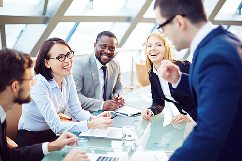 Business people laughing together at meeting