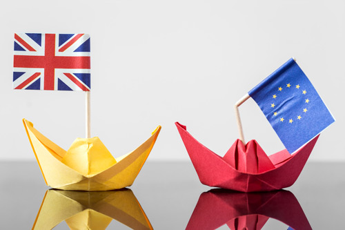 paper boats with British and EU flags