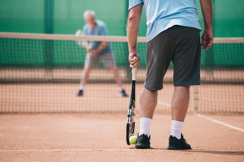 Elderly gentlemen playing tennis