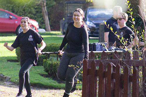 Kate and her team carrying a stretcher during the activity at Sandhurst