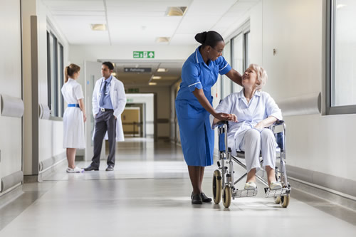 Nurse and patient in hospital corridor