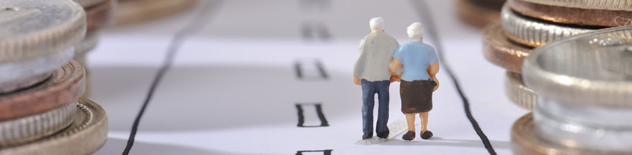 A miniature model of an elderly couple walking on a path between towering piles of coins