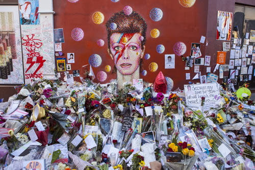 A David Bowie mural surrounded by flowers