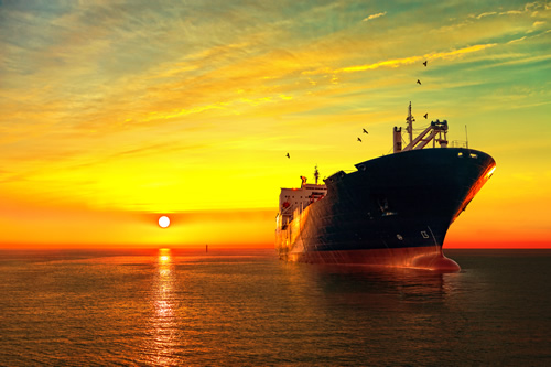 Oil tanker sailing at sunset